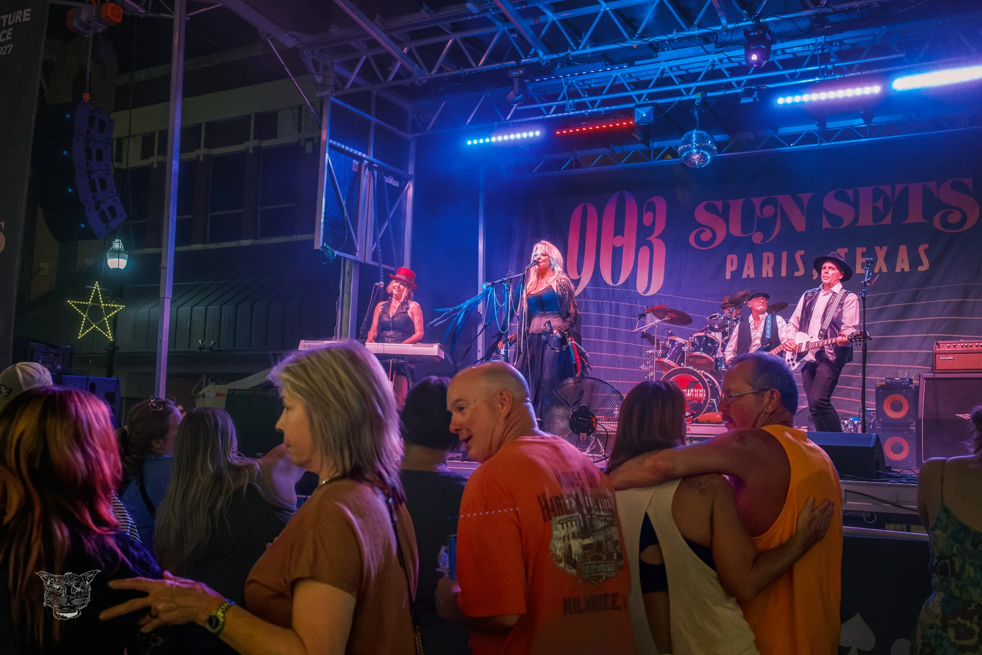 A live band performing under stage lights