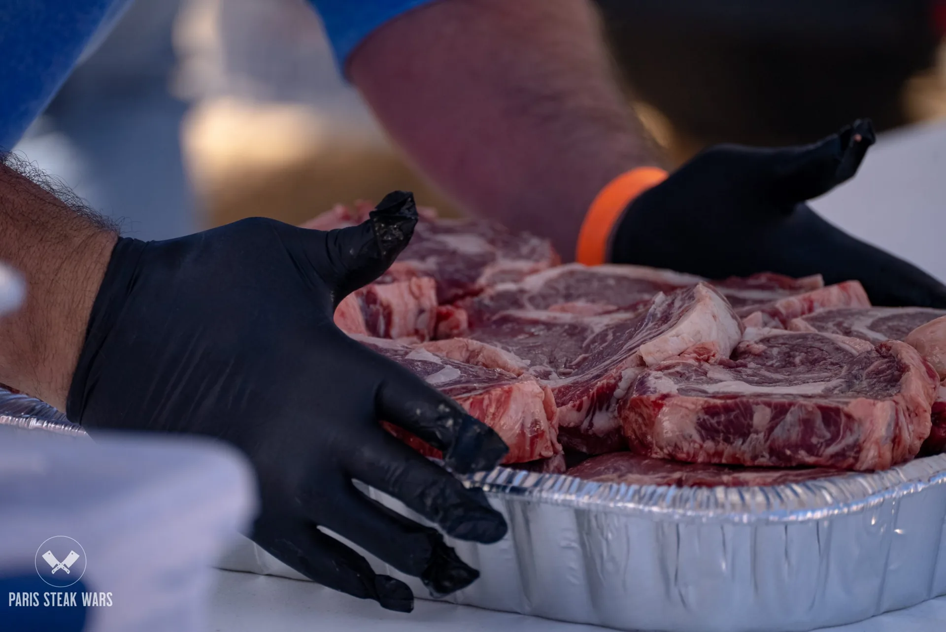 Steaks being seasoned at a previous Paris Steak Wars cook-off
